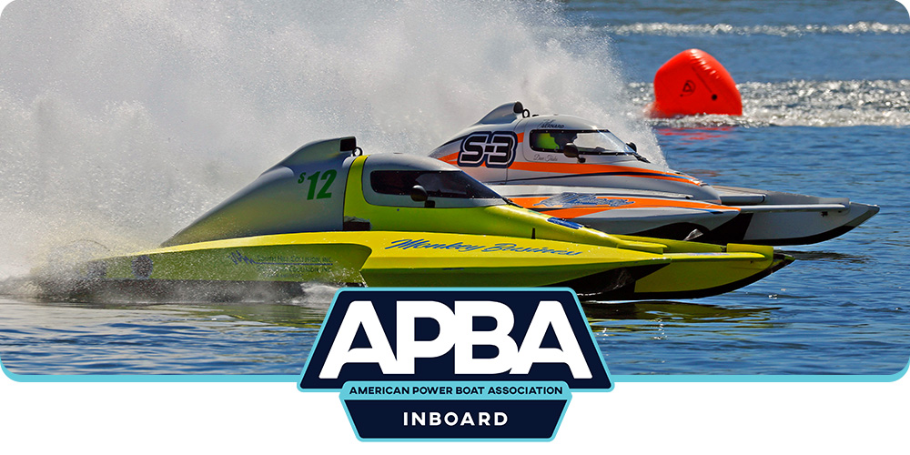 Two inboard hydroplane racing boats speed across the water during an APBA race, with spray trailing behind them and the APBA Inboard logo centered at the bottom of the image.