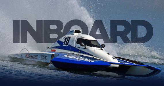 Blue and white inboard hydroplane race boat speeding across the water with large “INBOARD” text in the background and water spray behind the boat.