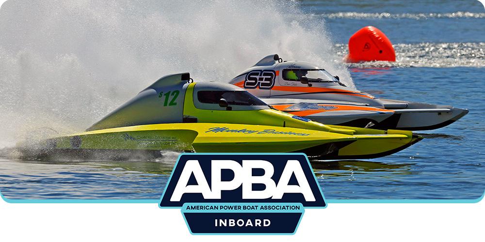 Two inboard hydroplane racing boats speed across the water during an APBA race, with spray trailing behind them and the APBA Inboard logo centered at the bottom of the image.