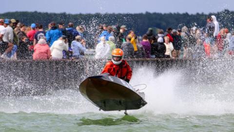 Gray runabout catching some air